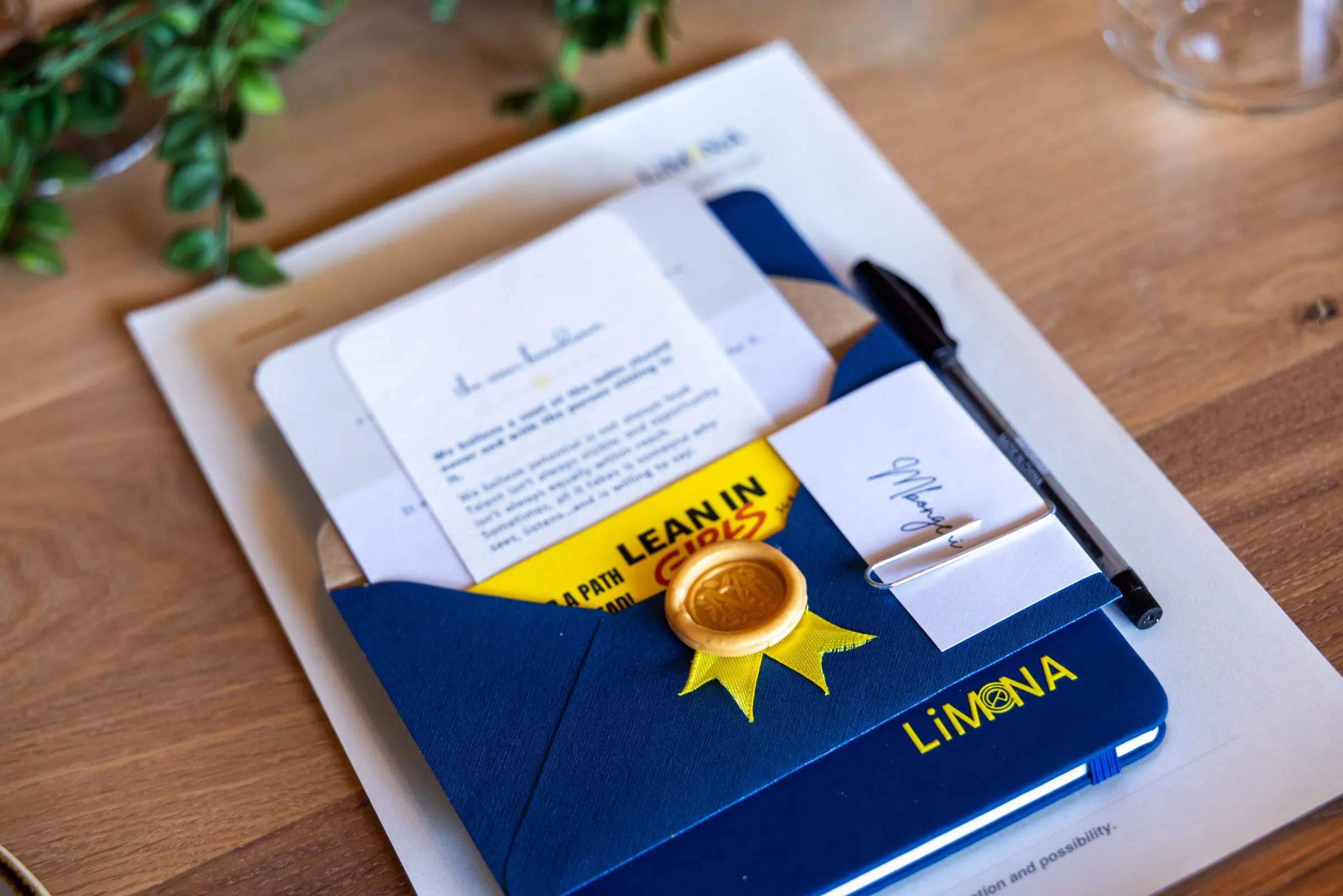 A LiMona notebook and welcome card at a place setting