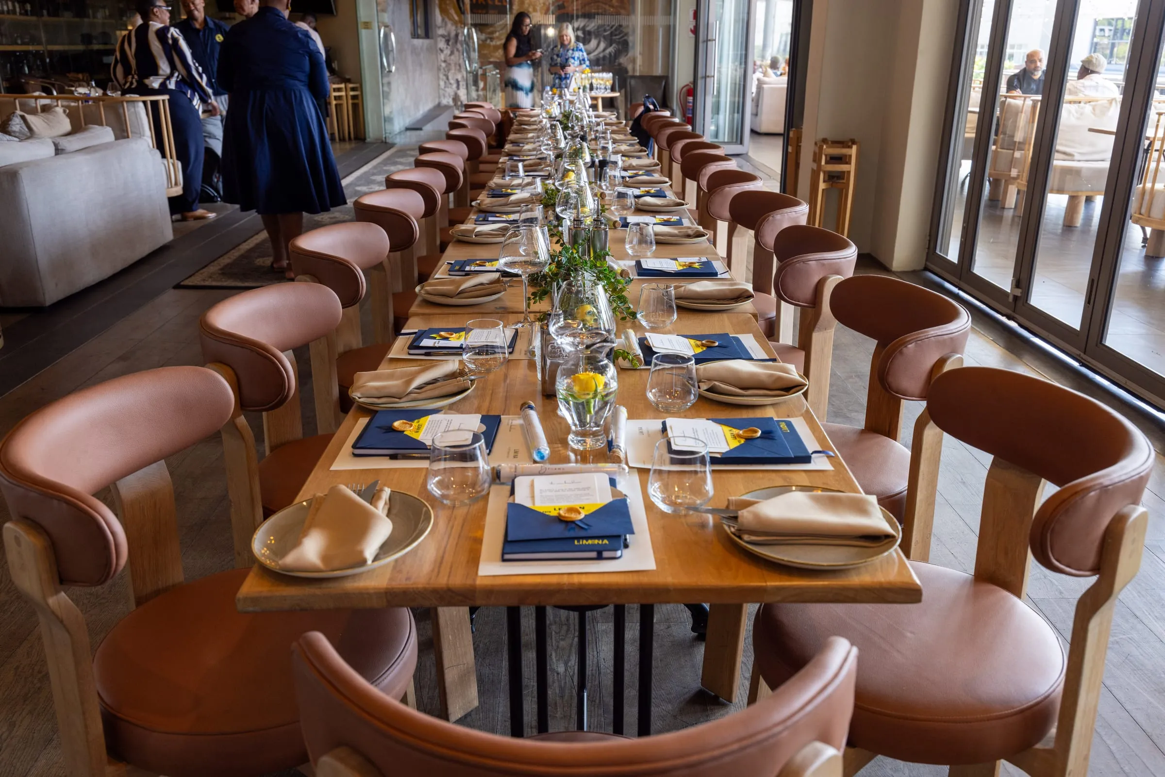 The long lunch table set and waiting for guests