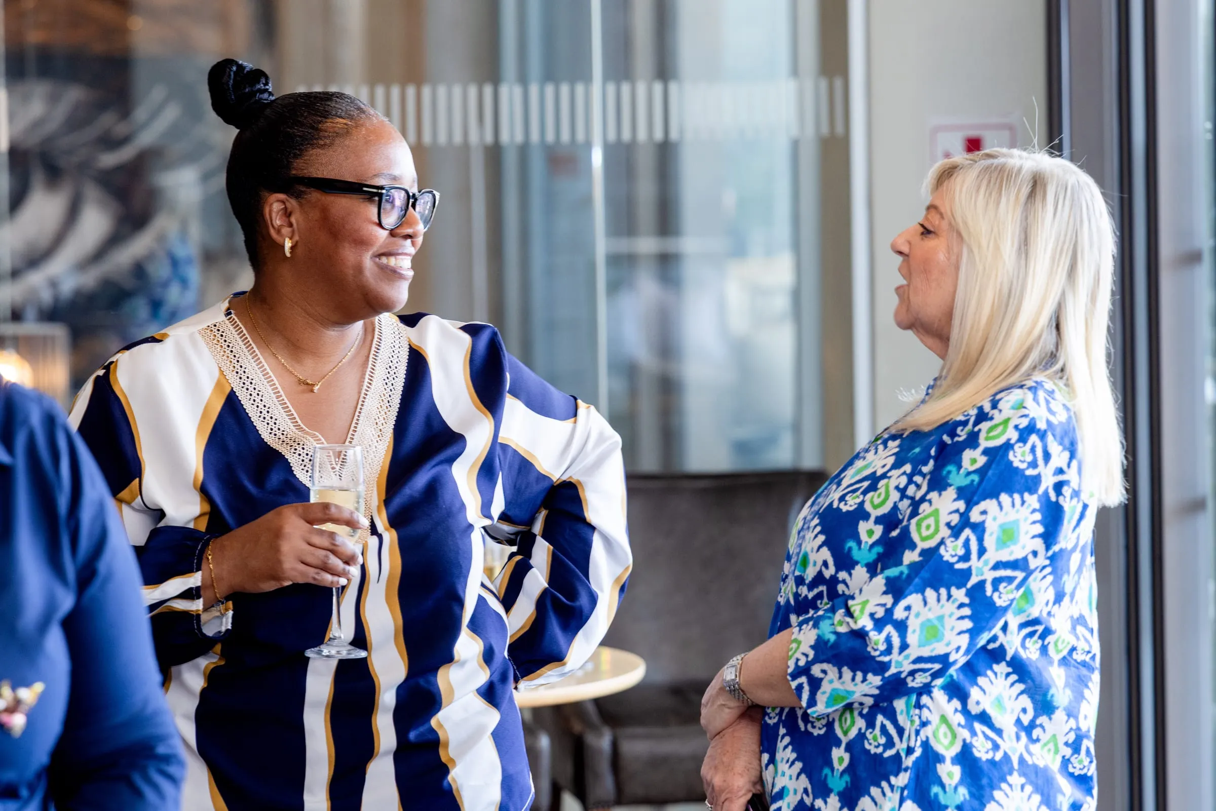 Guests in conversation by the windows