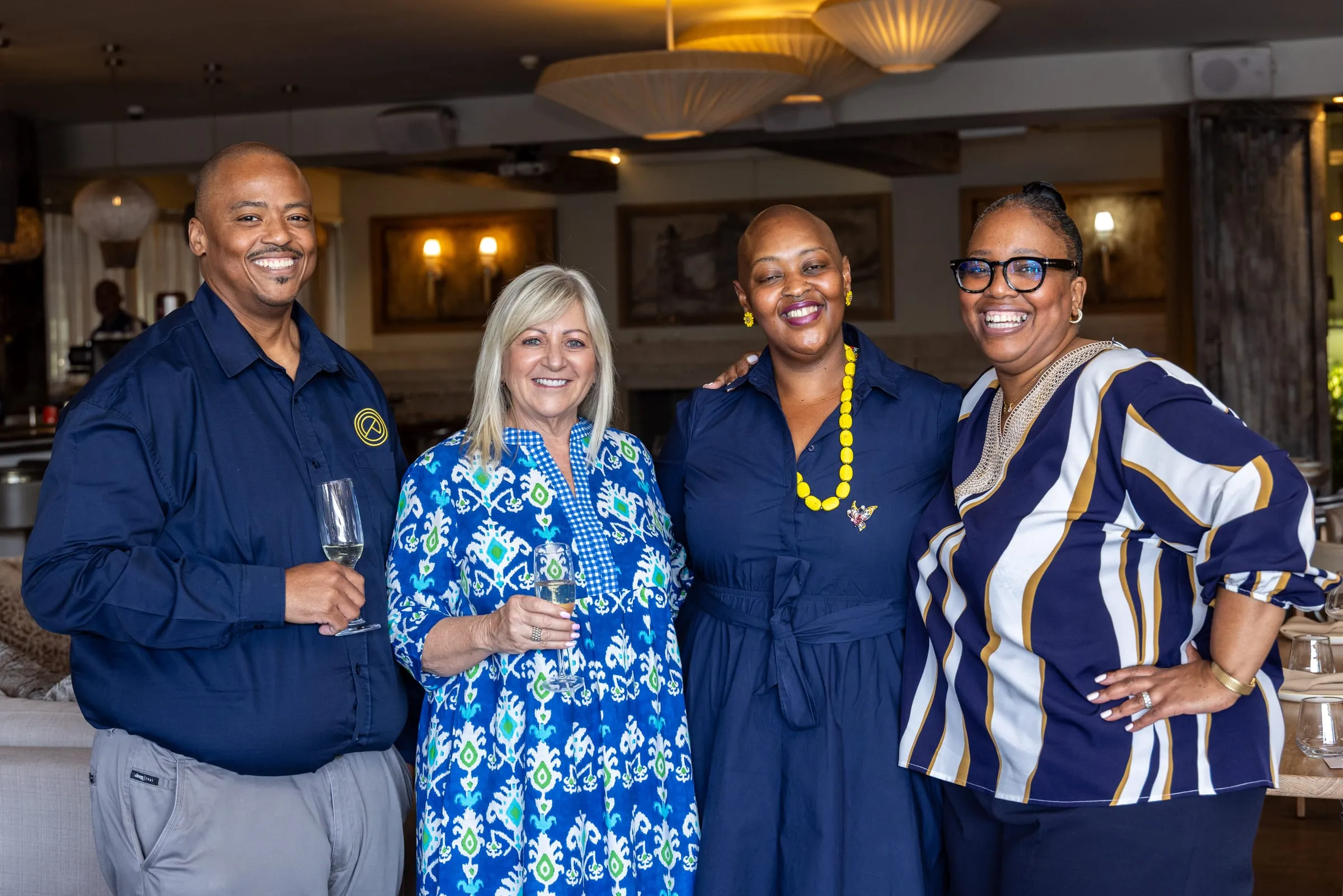 Four guests pause together for a photograph