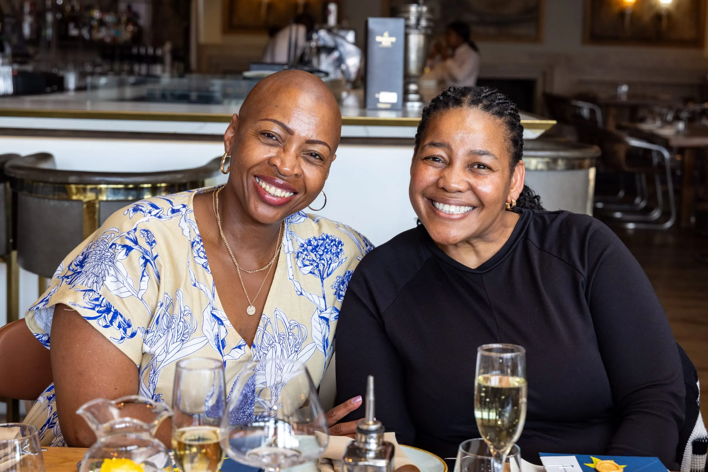Two guests share a smile at the table