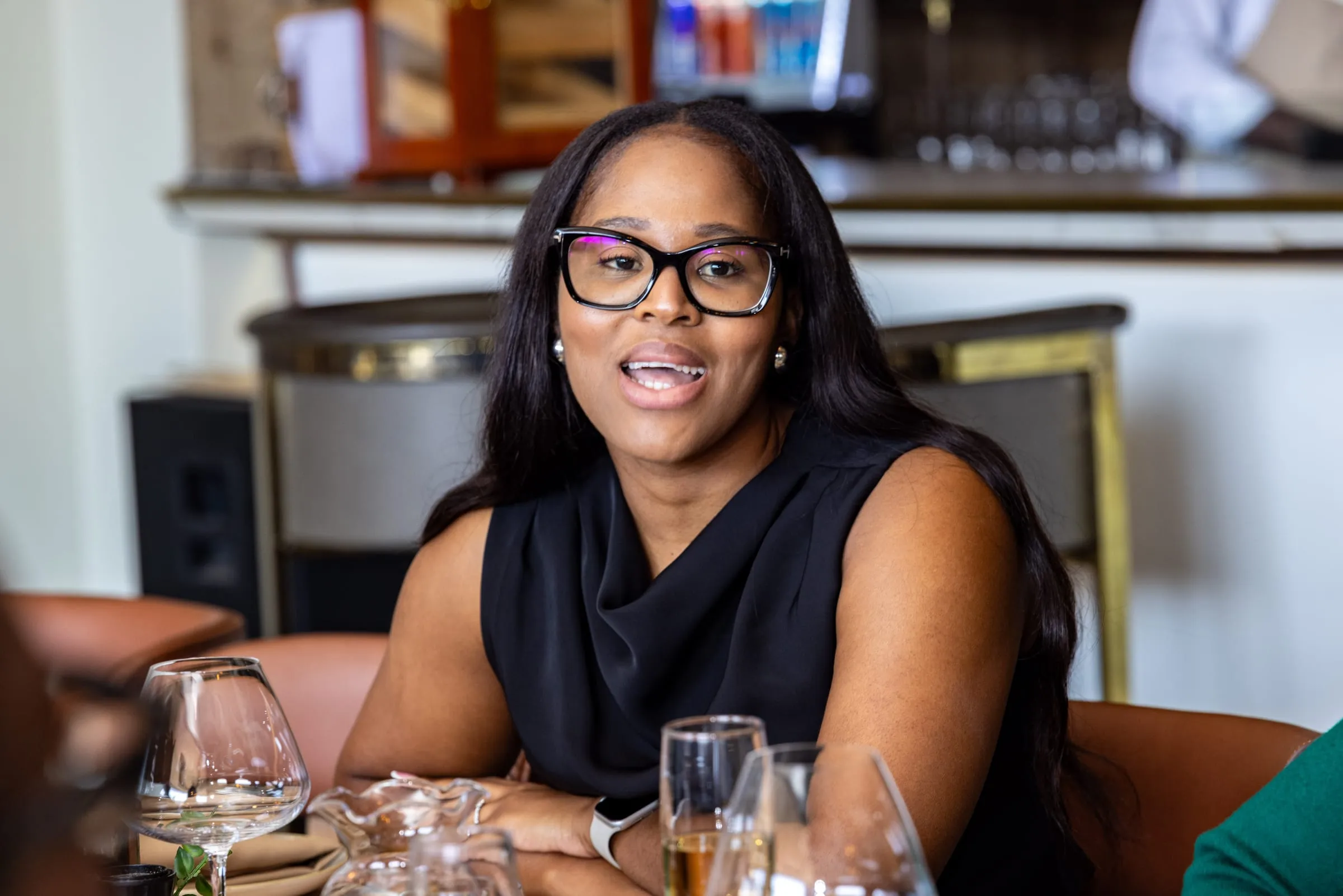 A guest smiles across the table