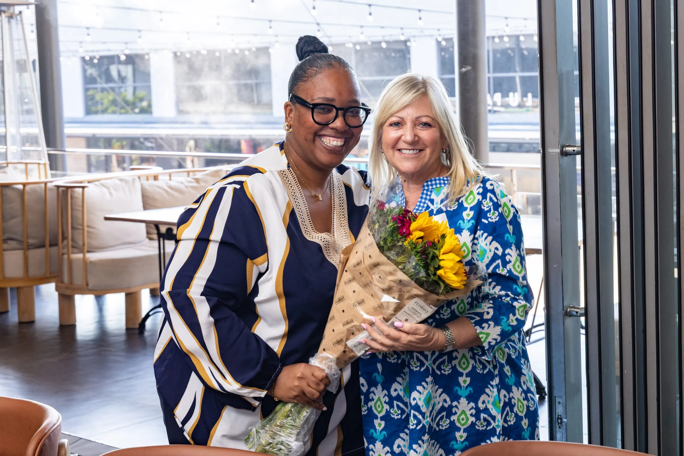 Two guests with flowers at the close of lunch