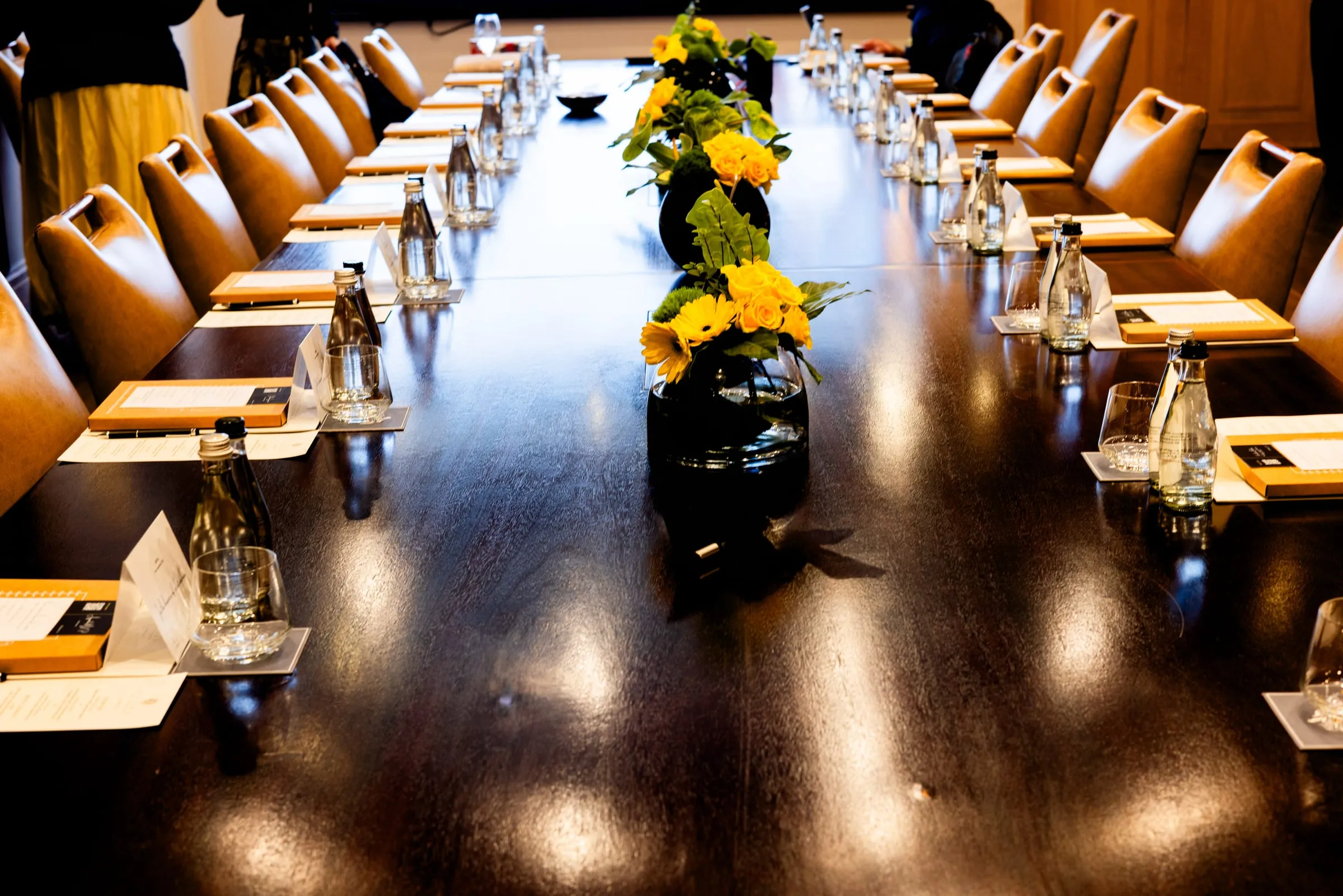 The boardroom table dressed with yellow flowers