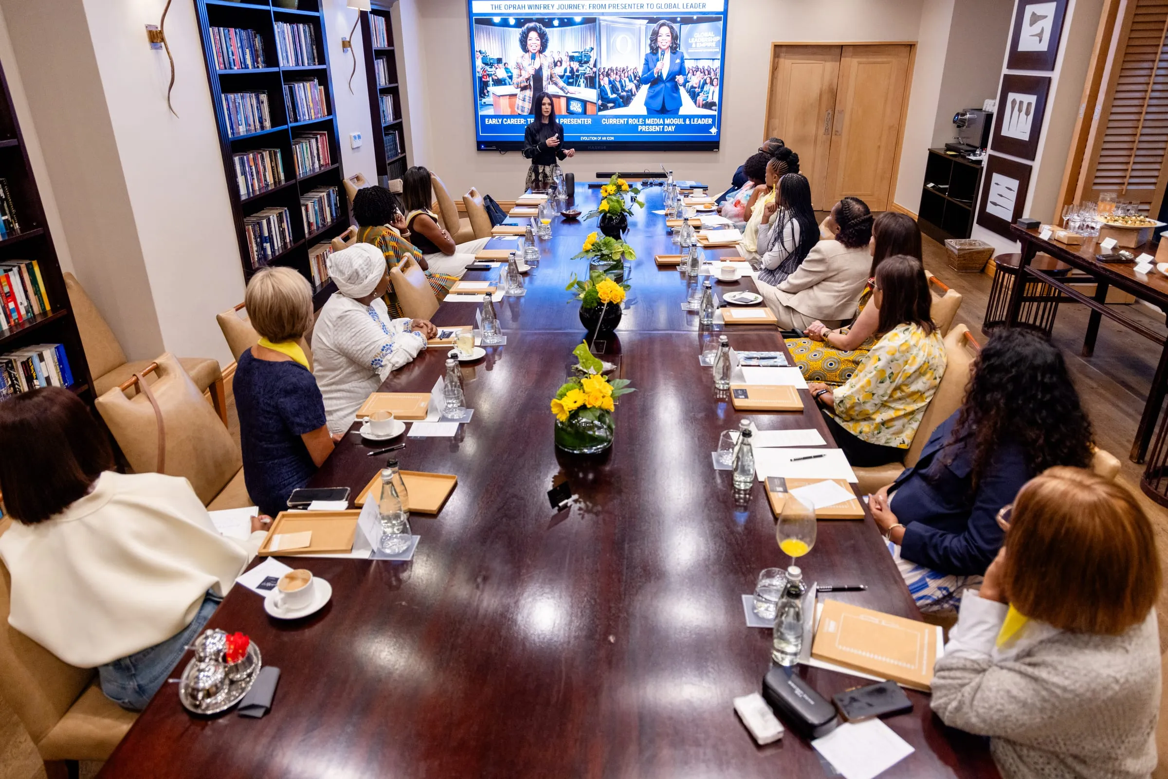 Guests seated along the boardroom table during the session